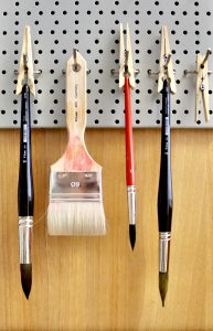 Hanging artist brushes drying