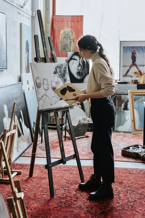 Woman painting a beautiful picture with an artists brush